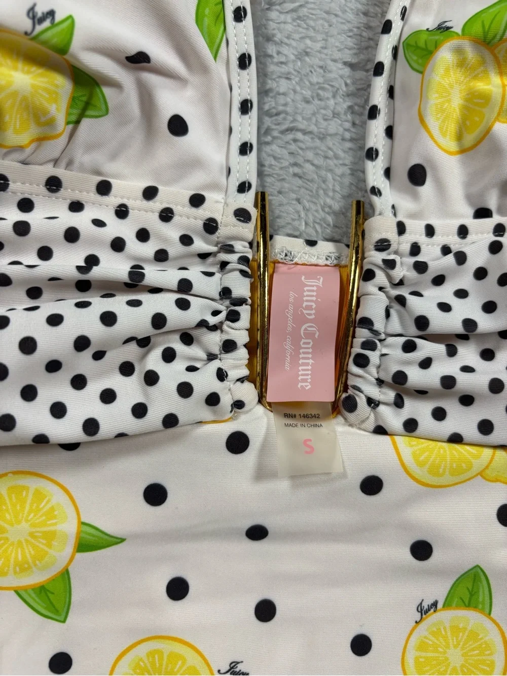 Juicy Couture yellow and white polka dot one piece swimsuit.